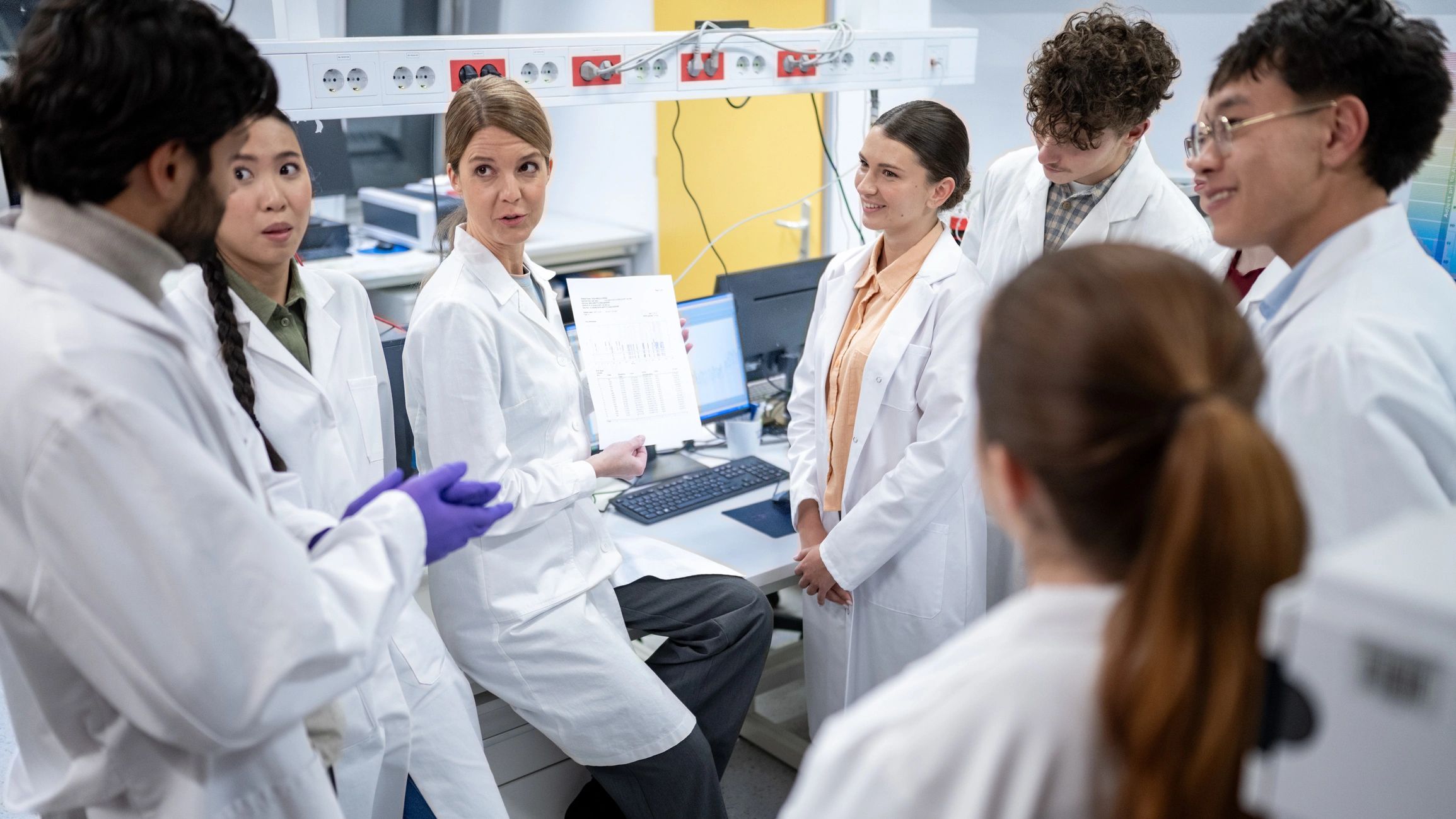 Research team collaborating in a modern laboratory